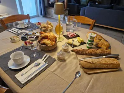 a table topped with bread and pastries on a table at Chambre d'hôte in Revel