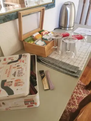 a counter top with a table with a box on it at Chambre de charme in Cavanac