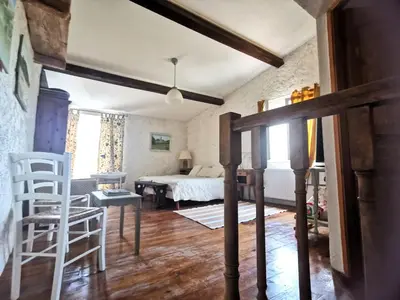 a bedroom with a bed and a table and chairs at Chambre de charme in Cavanac