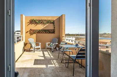 a patio with chairs and a table on a balcony at Appartement 
