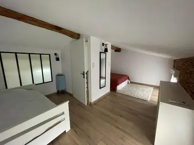 a bedroom with a bed and a small room with at Industrial Lodge 85m² - Loft avec extérieur in Revel
