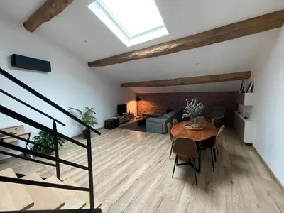 a living room with a table and a couch at Industrial Lodge 85m² - Loft avec extérieur in Revel