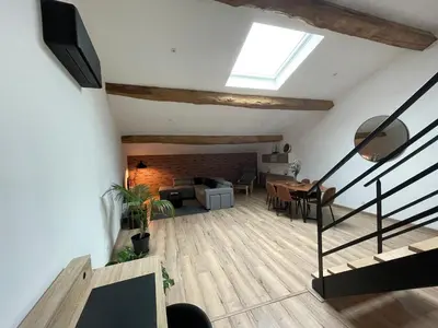 a living room with stairs and a dining room at Industrial Lodge 85m² - Loft avec extérieur in Revel