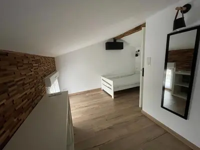 a living room with a mirror and a bedroom at Industrial Lodge 85m² - Loft avec extérieur in Revel