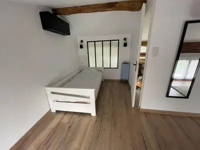 a small room with a white bed and a mirror at Industrial Lodge 85m² - Loft avec extérieur in Revel