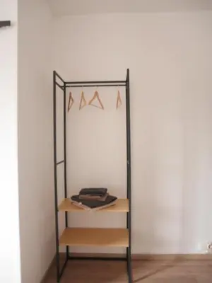a shelf in a room next to a wall at Le Laurenti in Quérigut