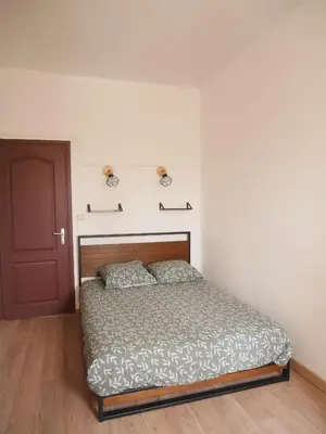 a bedroom with a bed and a red door at Le Laurenti in Quérigut