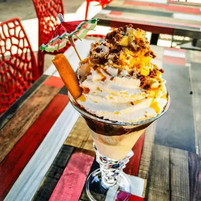 an ice cream sundae in a glass cup on a table at Le Laurenti in Quérigut