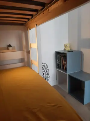 a bedroom with a bed and a book shelf at Studio mer Neuf Port la Nouvelle in Port-la-Nouvelle