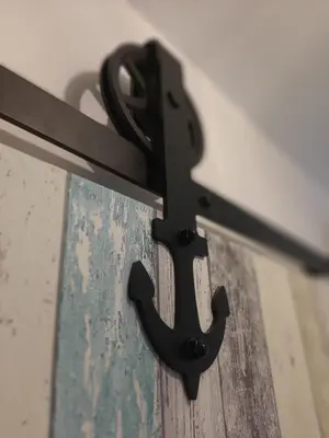 a black metal bracket attached to a wall at Studio mer Neuf Port la Nouvelle in Port-la-Nouvelle