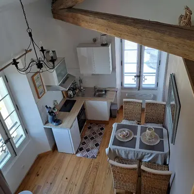 an overhead view of a kitchen with a table and chairs at La Maison du Canal- vue Canal- L'ère du Temps in Homps
