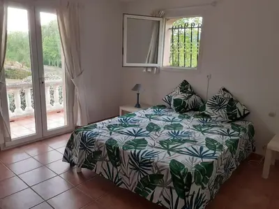 a bedroom with a bed and a window at Belle villa entre garrigue et rivière in Saint-Chinian