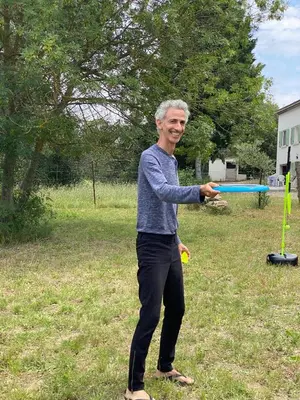 a man is swinging a bat at a ball at Zen Experience including Yoga & Healthy food in Ladern-sur-Lauquet