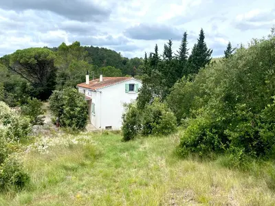 a small white house in the middle of a field at Zen Experience including Yoga & Healthy food in Ladern-sur-Lauquet