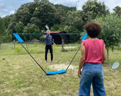 a man and a woman playing a game with rackets at Zen Experience including Yoga & Healthy food in Ladern-sur-Lauquet