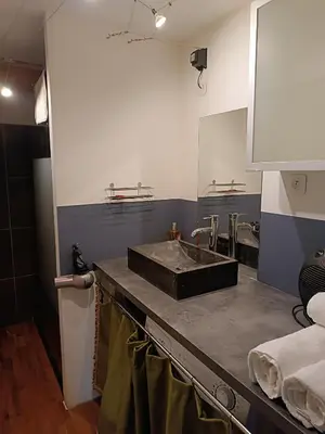 a bathroom with a sink and two sinks at Charmante maison village QUERIGUT in Quérigut