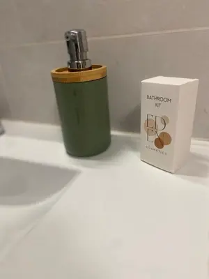 a green lighter next to a box on a counter at Le Canal - Appartement avec vue 4 personnes in La Redorte
