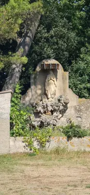 a stone structure with a statue on top of it at Domaine VILLECARLA Gîte 1, Canal du Midi Carcassonne in Villedubert