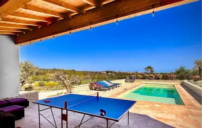 a ping pong table on a patio next to a pool at Cozy Home In Stjean-De-Minervois in Saint-Jean-de-Minervois
