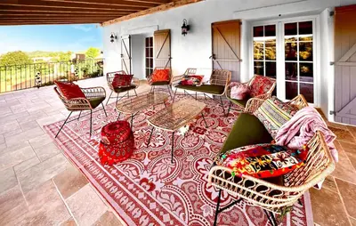 a patio with chairs and tables on a rug at Cozy Home In Stjean-De-Minervois in Saint-Jean-de-Minervois