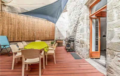a patio with a table and chairs and a grill at Awesome Home In Peyriac-Minervois in Peyriac-Minervois