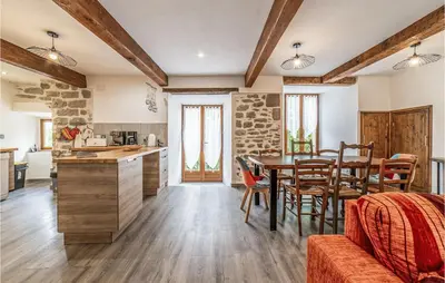 a kitchen and dining room with a table and chairs at Awesome Home In Peyriac-Minervois in Peyriac-Minervois