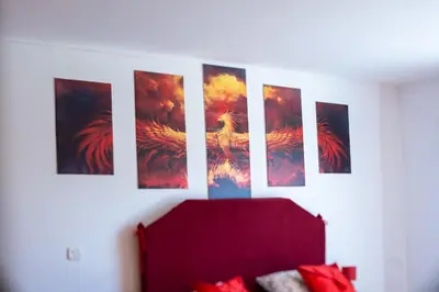 a bunch of paintings hanging on a wall at Chez PhiL in La Pomarède