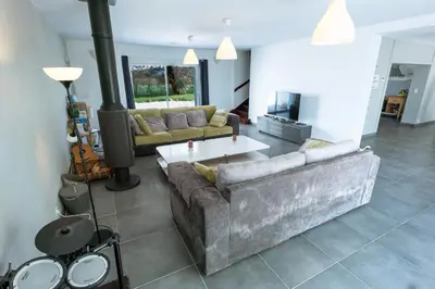 a living room with a couch and a table at Chez PhiL in La Pomarède