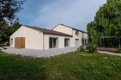 a white house with a yard in front of it at Chez PhiL in La Pomarède
