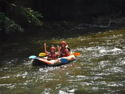 two people are in a raft on a river at Mountain Retreat w Terrace in Quillan