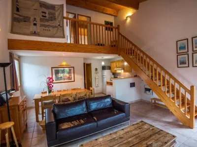 a living room with a couch and a staircase at Mountain Retreat w Terrace in Quillan