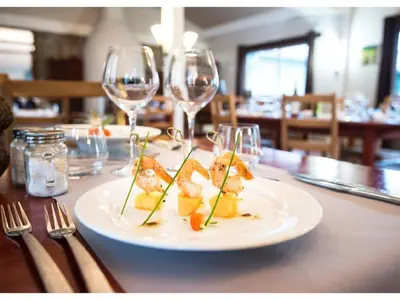 a plate of food on a table with wine glasses at Scenic Retreat w Terrace in Quillan