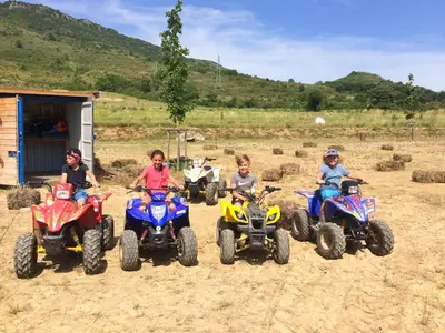 a group of children riding atvs on a dirt field at Scenic Retreat w Terrace in Quillan