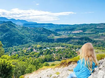 a woman sitting on the edge of a mountain looking at a valley at Scenic Retreat w Terrace in Quillan