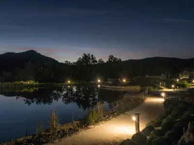 a view of a lake at night with lights at Peaceful Pyrenees Retreat in Quillan
