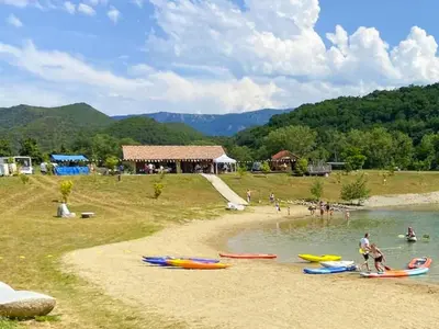 a group of people on a beach with boats in the water at Peaceful Pyrenees Retreat in Quillan
