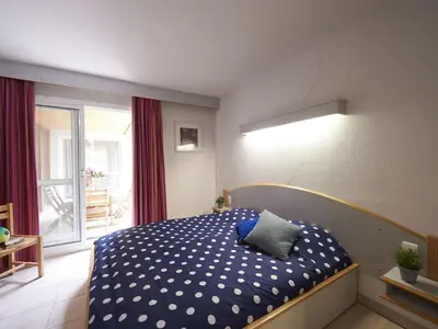 a bedroom with a bed with a blue comforter at Pet-Friendly Home w Garden in Quillan
