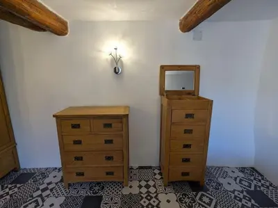a room with two dressers and a mirror on a wall at Maison Porte Saint Croix in Bize-Minervois