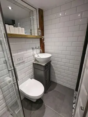 a bathroom with a toilet and a sink and a mirror at Maison Porte Saint Croix in Bize-Minervois
