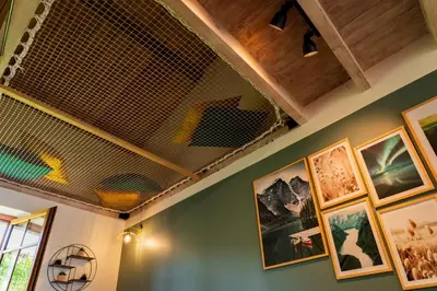 a room with paintings on the walls and a ceiling at Les gîtes du Canal du midi - Gîte Loft'Oten in Avignonet-de-Lauragais