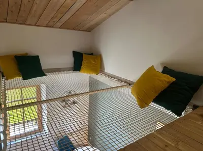 a room with yellow and green pillows on a couch at Les gîtes du Canal du midi - Gîte Loft'Oten in Avignonet-de-Lauragais