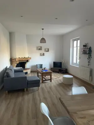 a living room with a couch and a table at Maison La Vielmuroise in Vielmur-sur-Agout