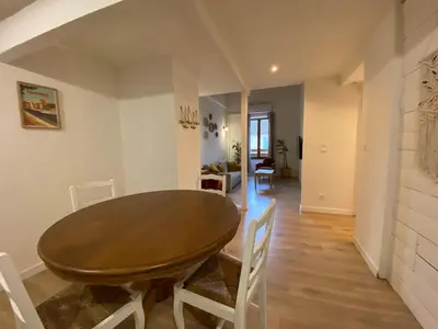 a dining room with a wooden table and chairs at T3 bord canal du midi, piscine in Homps