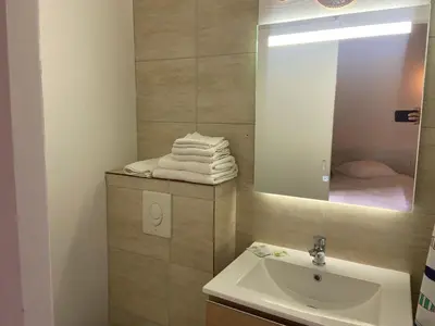 a bathroom with a sink and a mirror at T3 bord canal du midi, piscine in Homps