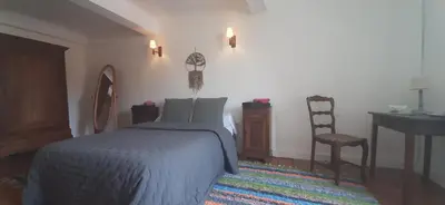a bedroom with a bed and a desk and a chair at Maison isivier in Magrie