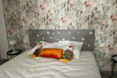 two stuffed animals laying on a bed with pillows at Studio pour 2 personnes proche Canal du Midi - Ventenac en Minervois in Ventenac en Minervois