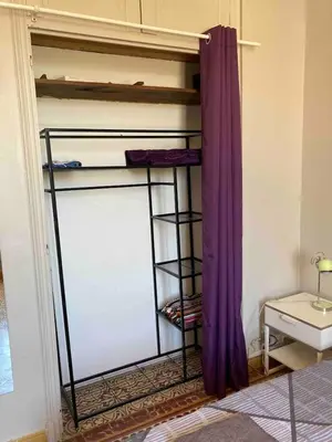 a room with a bunk bed with purple curtains at Danoss Cool Stay in Narbonne