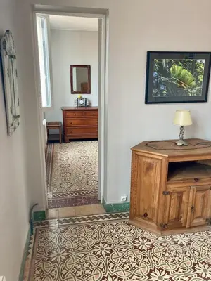 a hallway with a room with a table and a mirror at Danoss Cool Stay in Narbonne
