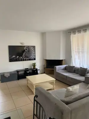 a living room with two couches and a table at Villas du Golf Domaine Royal Green in Pont-de-Larn