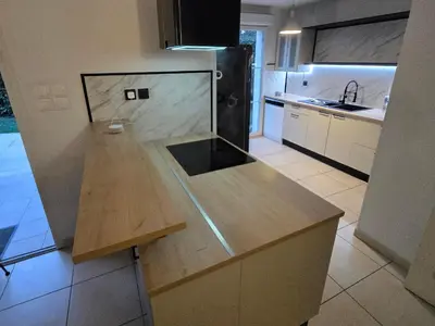a kitchen with a wooden counter top in a room at Villas du Golf Domaine Royal Green in Pont-de-Larn